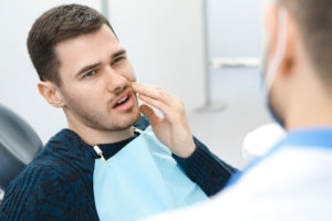 Dental Patient Suffering From Dental Pain In A Dental Chair