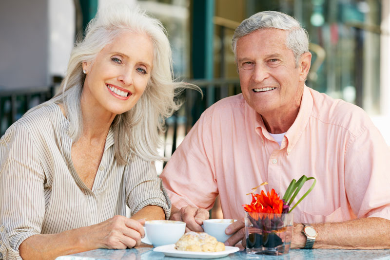 elderly couple smiling after their dental implant procedure